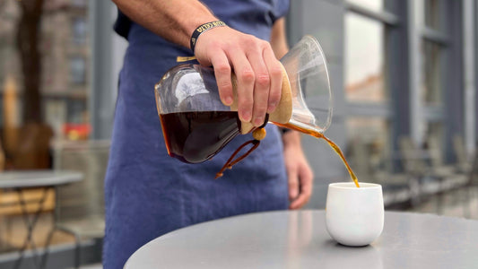 Image of a Chemex filled with tasty coffee in front of THE BARN coffee shop