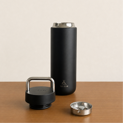 FELLOW CARTER CARRY TUMBLER in matte black with a handle and lid, showcasing its sleek design and insulation features.