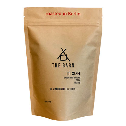 Kraft paper coffee bag with 'The Barn' branding and coffee details on a white background