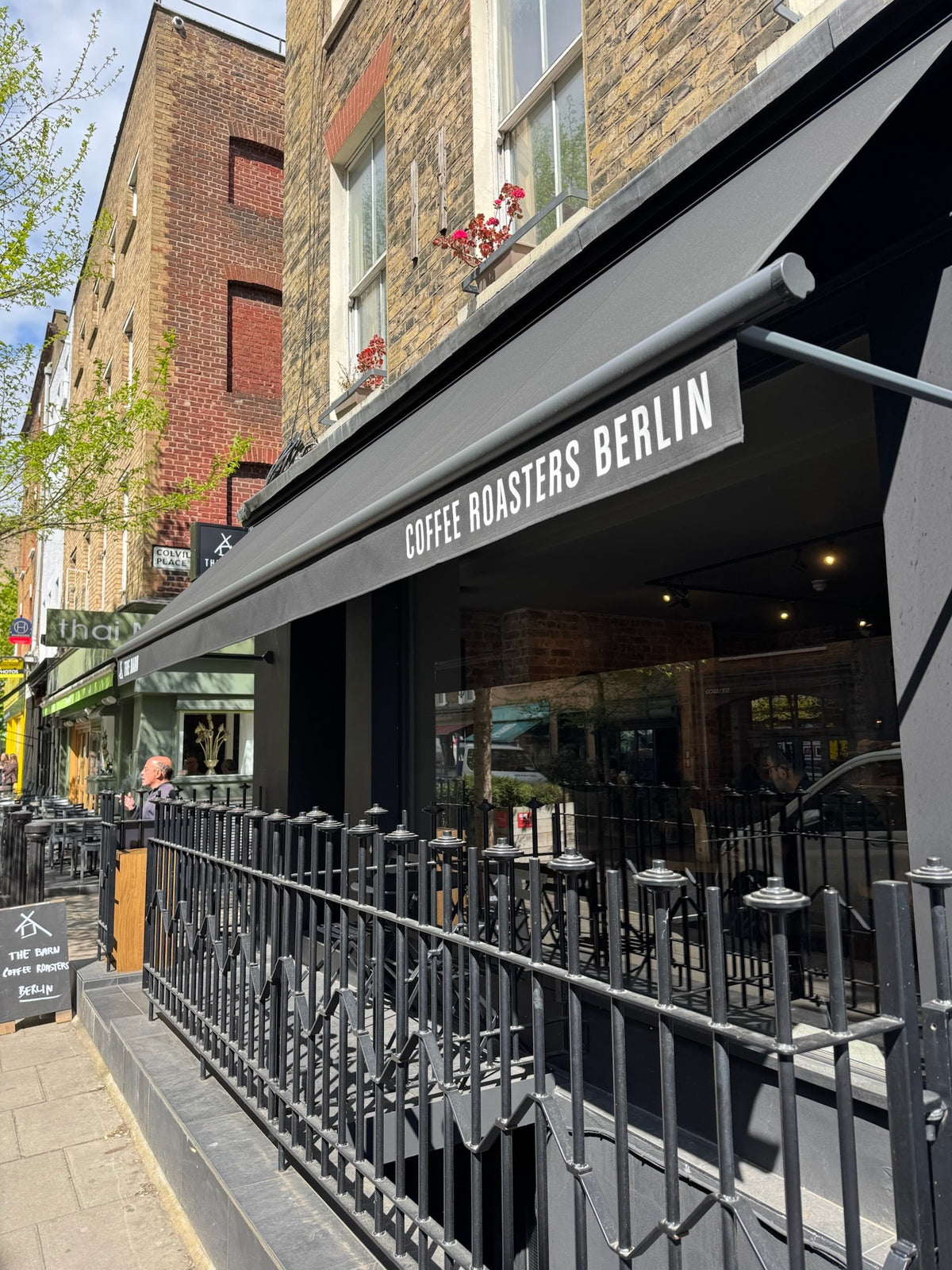 Exterior view of THE BARN café London with sunny terrace.