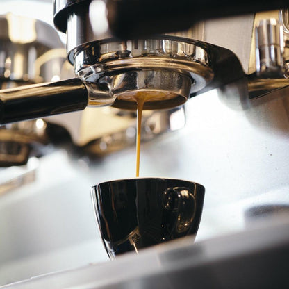 Espresso dripping out from La Marzocco into a cup